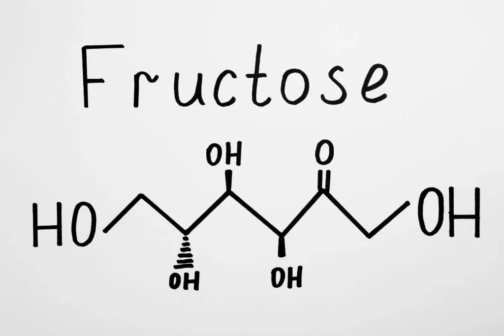 Formule chimique du fructose avec groupes hydroxyles et cétone, image liée à la biochimie des glucides