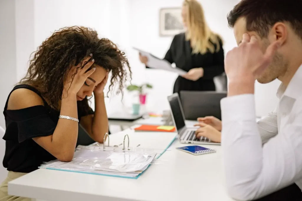 Personne assise devant des documents reflétant la tension et la rigueur nécessaires pour comprendre la connexion intestin-cerveau.